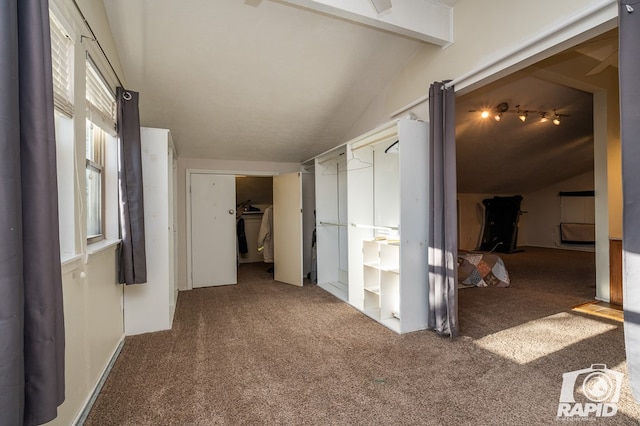 hall featuring lofted ceiling with beams and carpet flooring