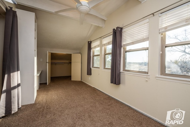 unfurnished bedroom with a closet, carpet, and vaulted ceiling with beams