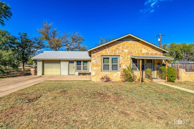 ranch-style home featuring a porch, a garage, and a front yard