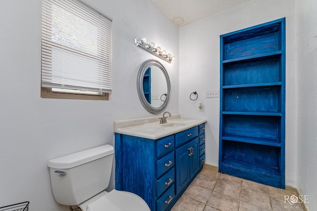 bathroom featuring vanity, a textured ceiling, and toilet