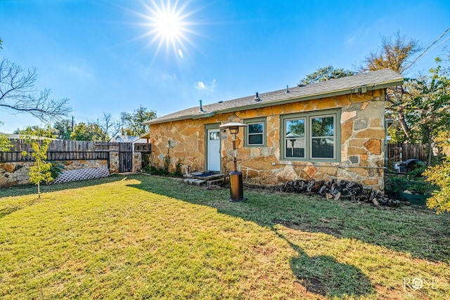 back of house with a yard