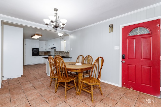 3237 Red Bluff Rd W, San Angelo, TX 76904 - dining room featuring light tile patterned floors, a chandelier, and ornamental molding