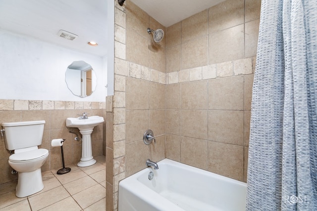 3237 Red Bluff Rd W, San Angelo, TX 76904 - full bath with shower / tub combo with curtain, tile walls, toilet, and tile patterned flooring