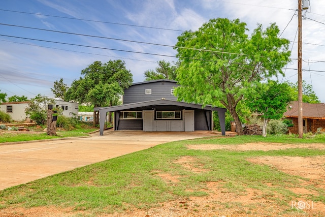 3237 Red Bluff Rd W, San Angelo, TX 76904 - view of front of home with concrete driveway, a carport, and a front lawn