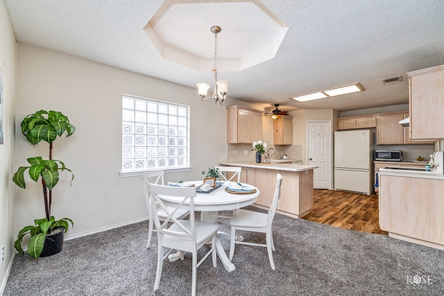 5221 Coral Way, San Angelo, TX 76904 - dining room featuring a textured ceiling, a chandelier, dark carpet, ceiling fan, and baseboards