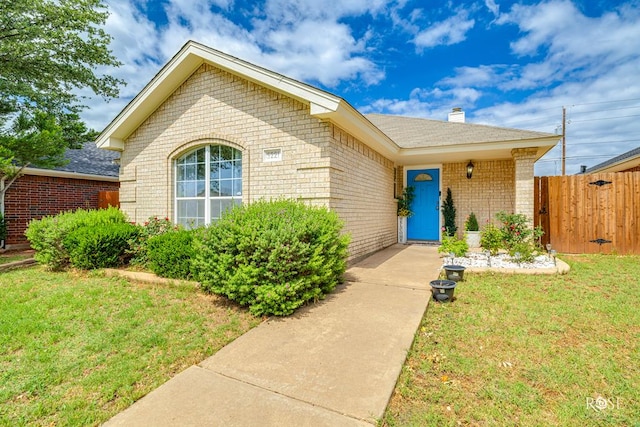 5221 Coral Way, San Angelo, TX 76904 - view of front facade with brick siding, a chimney, and a gate