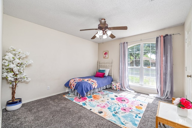 5221 Coral Way, San Angelo, TX 76904 - carpeted bedroom with a textured ceiling, ceiling fan, and baseboards