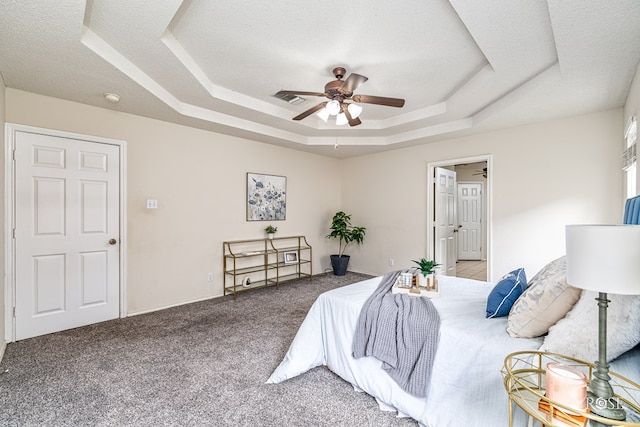 5221 Coral Way, San Angelo, TX 76904 - carpeted bedroom with a raised ceiling, a textured ceiling, and a ceiling fan