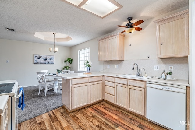 5221 Coral Way, San Angelo, TX 76904 - kitchen with light brown cabinetry, white appliances, a sink, a peninsula, and a textured ceiling
