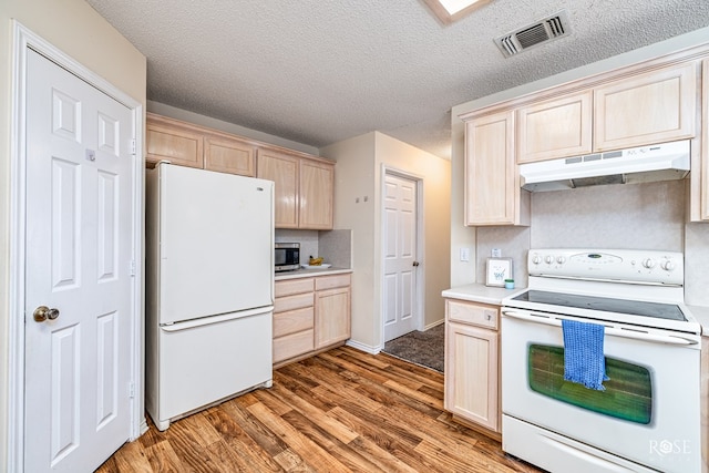 5221 Coral Way, San Angelo, TX 76904 - kitchen featuring white appliances, under cabinet range hood, light brown cabinets, light countertops, and light wood-type flooring