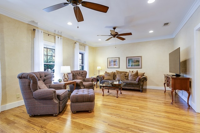 living room with light hardwood / wood-style flooring, ornamental molding, and ceiling fan