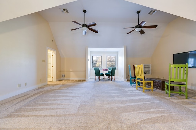 carpeted living room with ceiling fan and high vaulted ceiling