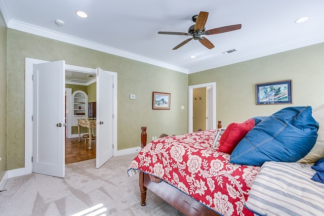 carpeted bedroom with ceiling fan and ornamental molding