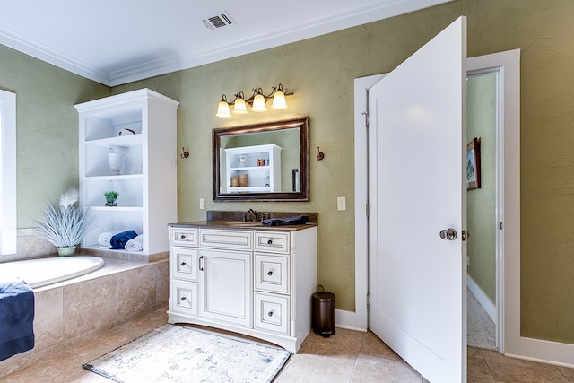 bathroom with vanity, tile patterned flooring, crown molding, and tiled tub