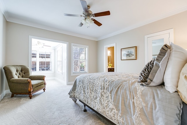 bedroom featuring ceiling fan, ensuite bath, crown molding, and carpet