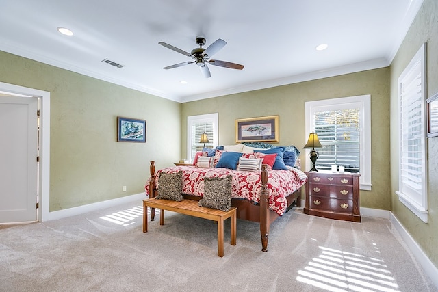 carpeted bedroom featuring crown molding and ceiling fan