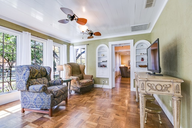 sitting room featuring ceiling fan, parquet floors, wood ceiling, and built in shelves