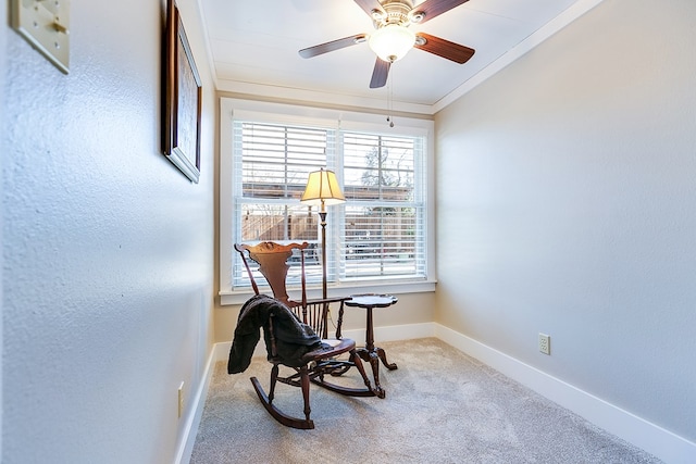 sitting room with crown molding, ceiling fan, a healthy amount of sunlight, and carpet flooring