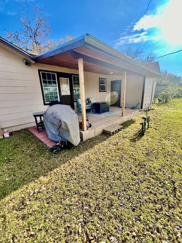 back of house featuring a yard and a patio area