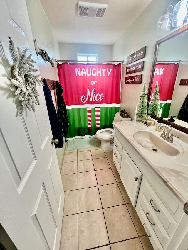 bathroom featuring tile patterned floors, toilet, and vanity