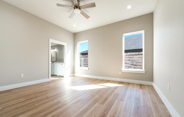 empty room with light hardwood / wood-style flooring, a wealth of natural light, and ceiling fan