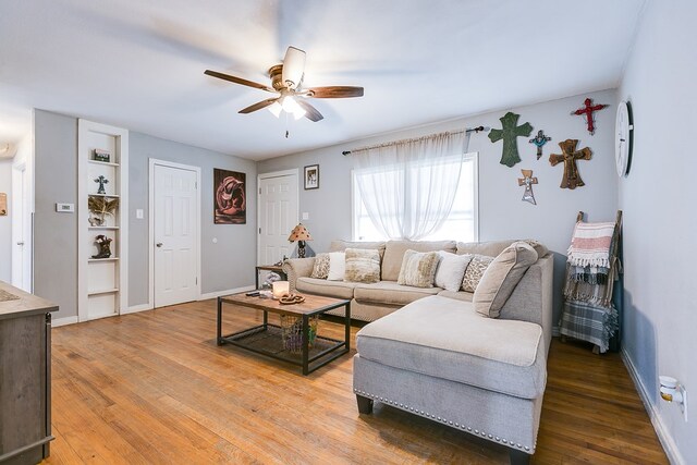 1632 Mission Ave, San Angelo, TX 76905 - living area featuring a ceiling fan, built in shelves, light wood-style flooring, and baseboards