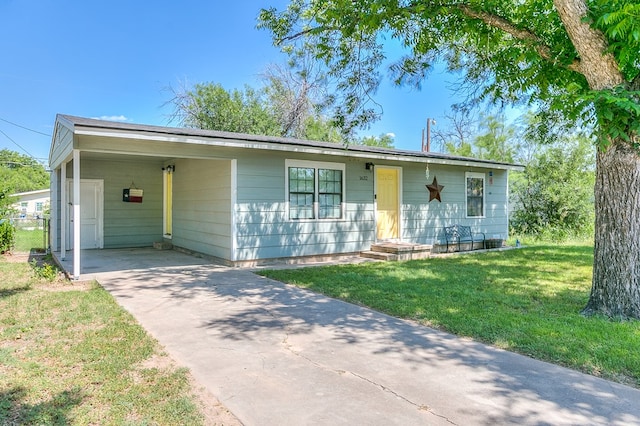 1632 Mission Ave, San Angelo, TX 76905 - view of front of house featuring concrete driveway, a front lawn, and a carport