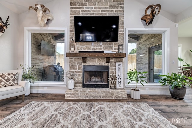 5949 Merrick St, San Angelo, TX 76904 - living room with a stone fireplace, wood finished floors, and plenty of natural light