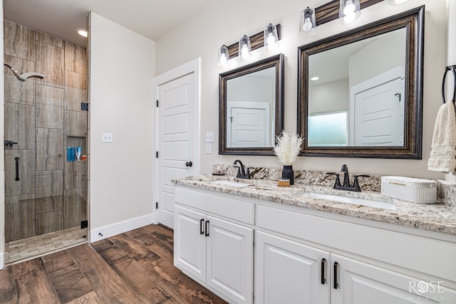 5949 Merrick St, San Angelo, TX 76904 - full bath featuring double vanity, a stall shower, wood finished floors, and recessed lighting