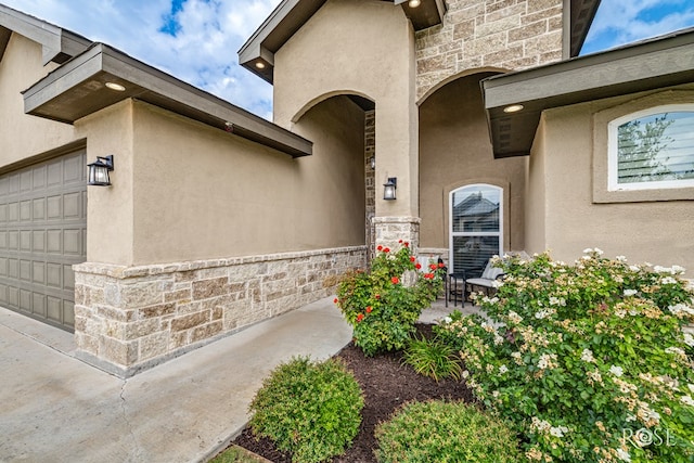 5949 Merrick St, San Angelo, TX 76904 - property entrance featuring stone siding, stucco siding, and an attached garage
