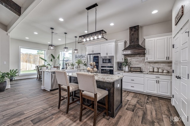5949 Merrick St, San Angelo, TX 76904 - kitchen with appliances with stainless steel finishes, custom range hood, dark wood-type flooring, white cabinetry, and recessed lighting
