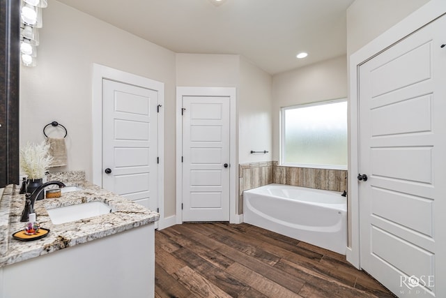 5949 Merrick St, San Angelo, TX 76904 - full bathroom with a bath, wood finished floors, vanity, and recessed lighting