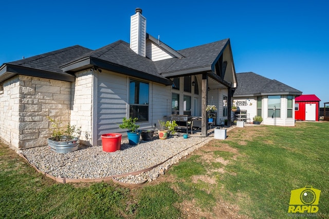3536 Jaguar Trl, San Angelo, TX 76901 - rear view of house featuring a lawn, a chimney, a patio area, and a shingled roof