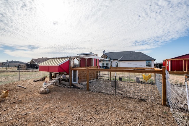 exterior space featuring an outbuilding, fence, and exterior structure