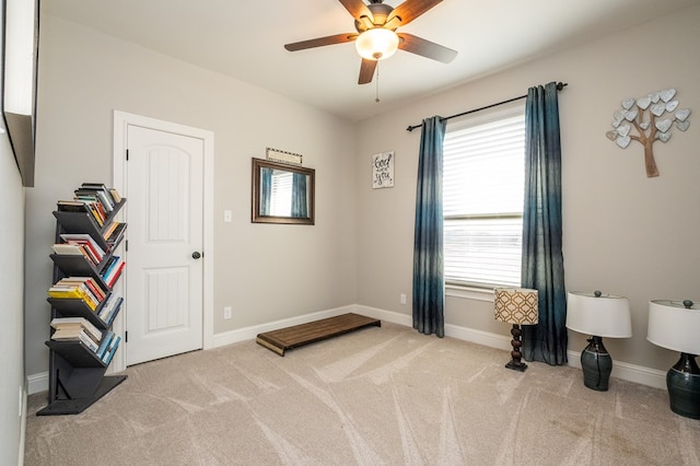 interior space with carpet floors, ceiling fan, and baseboards