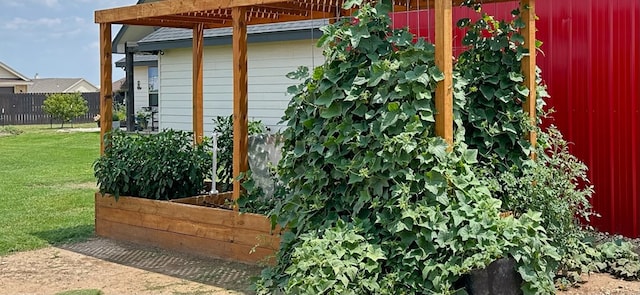 view of outbuilding featuring fence and a garden