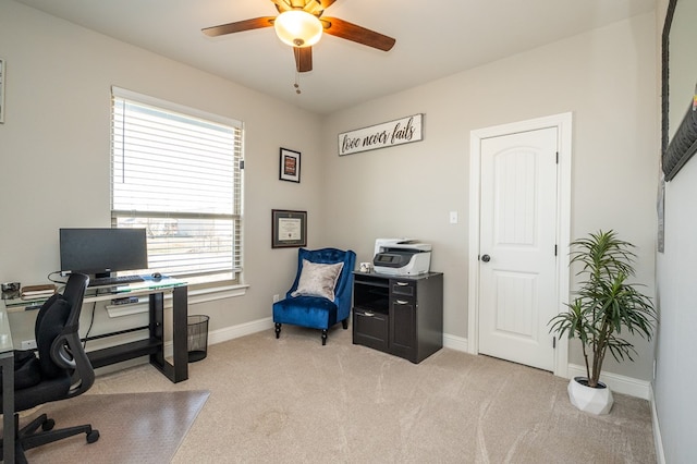 carpeted office featuring a ceiling fan and baseboards