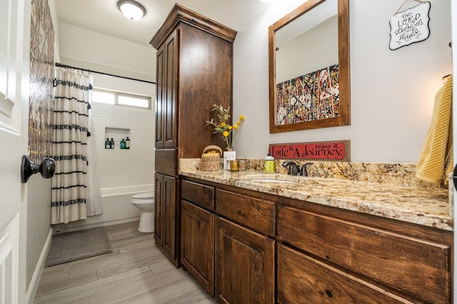 bathroom featuring shower / tub combo, vanity, toilet, and wood finished floors