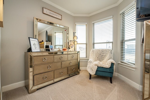 sitting room featuring baseboards, ornamental molding, a wealth of natural light, and light colored carpet