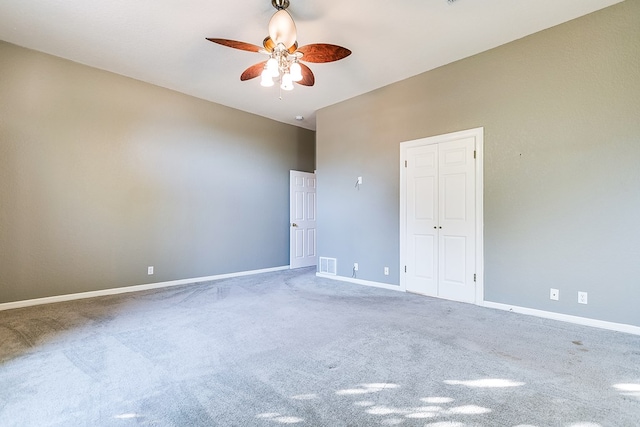 carpeted empty room with ceiling fan