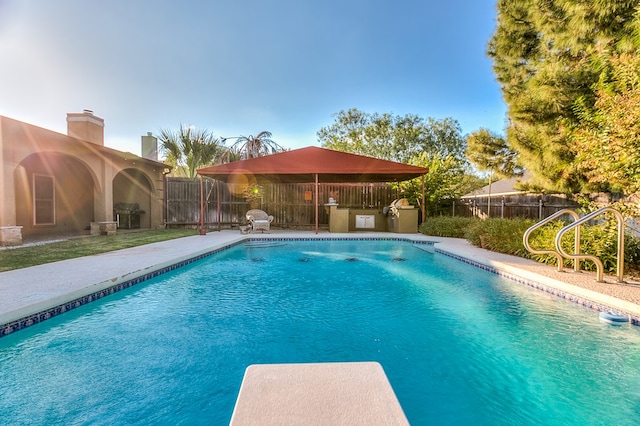 view of swimming pool with exterior kitchen