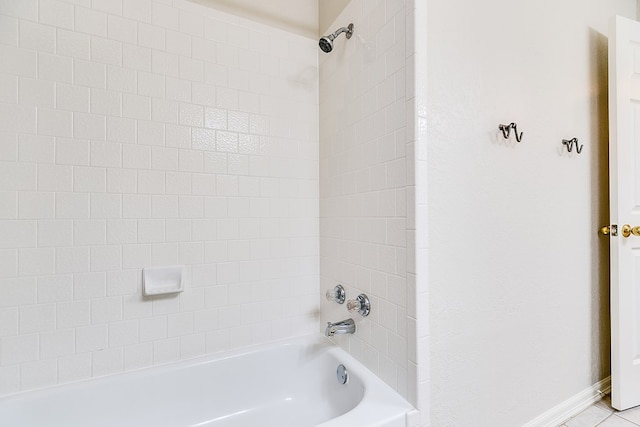 bathroom with bathtub / shower combination and tile patterned floors