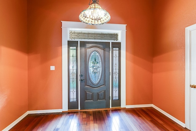 entrance foyer with wood-type flooring and an inviting chandelier