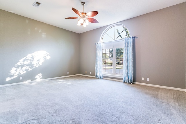 carpeted spare room with ceiling fan