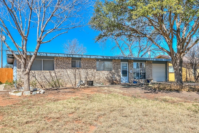 rear view of house with a garage and a lawn