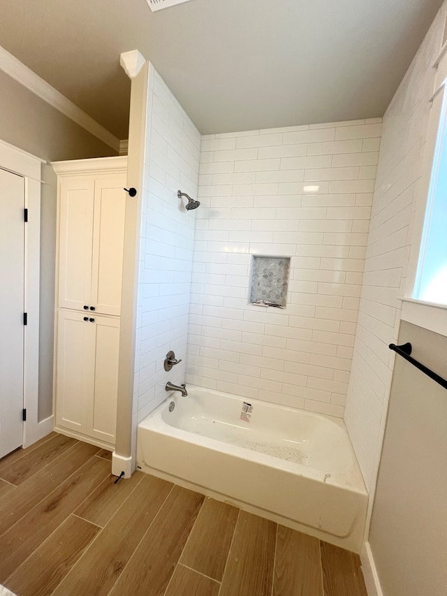 bathroom featuring  shower combination, wood tiled floor, and crown molding