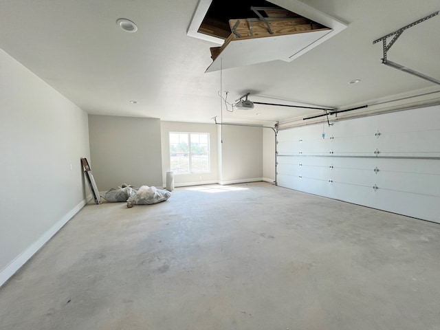 garage with a garage door opener and baseboards