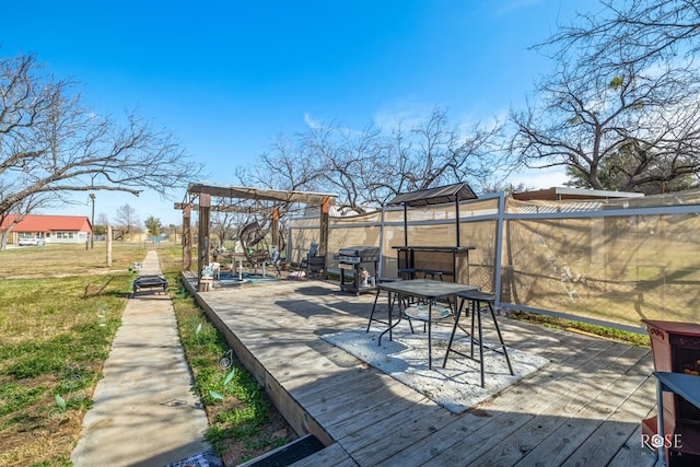 wooden terrace featuring area for grilling