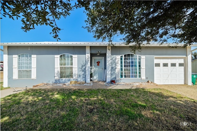 single story home featuring a garage and a front yard