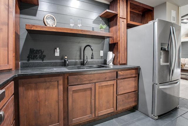 2030 Silver Creek Ct, San Angelo, TX 76904 - kitchen featuring stainless steel refrigerator with ice dispenser, open shelves, a sink, brown cabinetry, and tile patterned floors